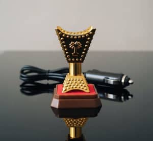 Spark hand car electric incense burner with decorative gold and red design for bakhoor